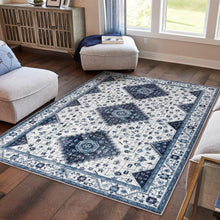 Blue and white patterned indoor area rug with geometric medallion and decorative border