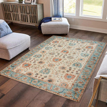 Area rug with distressed medallion pattern, ivory center and teal border