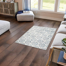 Washable indoor area rug, 3' x 5', light-blue medallion pattern on dark wood floor