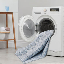 Washable indoor area rug, 3' x 5', light-blue medallion design in front of washer