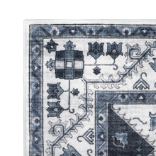 Blue and white rug corner with geometric blocks, ornamental trim, and patterned field