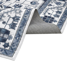 Blue and white patterned area rug corner lifted, showing woven texture and border print