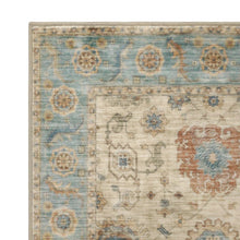 Washable indoor area rug corner view showing teal border and ivory patterned field