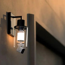 Wall-mounted security bulb cam light with frosted bulb and front camera lens