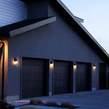 Outdoor wall light with bulb cam emitting warm light and visible camera module