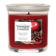 Yankee Candle Red Apple Wreath red tumbler candle in a clear glass jar
