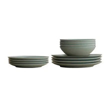 Gray-green dinner plates stacked in sets with matching shallow bowls