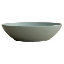 Mint green ceramic serving bowl with wide rim and shallow curve