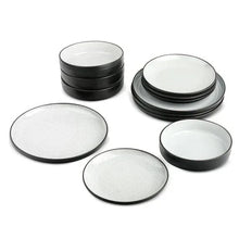 12-piece ceramic dinnerware set with white plates and black stackable rims