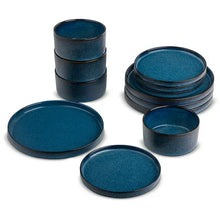 Teal ceramic dinnerware set with ridged cups, bowls, and plates stacked