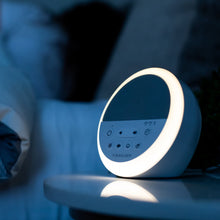 White and gray round sound machine with illuminated light ring and front controls