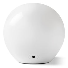 White round night sound machine with power button on the back