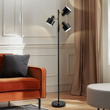 Black 3-head modern floor lamp with tilted spotlights and round base