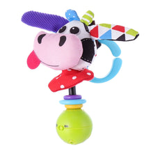 Pink plush cow rattle with purple ear and blue ring handle