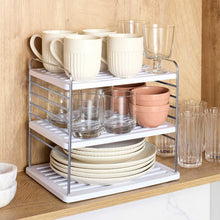 Bottle mug and plate organizer displaying mugs, glassware, and stacked plates on shelves