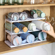 Bottle mug and plate organizer holding rolled mugs and glassware on wire shelves
