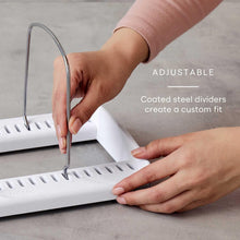 Adjustable white organizer tray with hands inserting coated steel divider bars