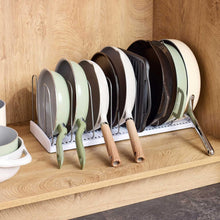 Cookware organizer set with white divider trays holding assorted baking pans and plates