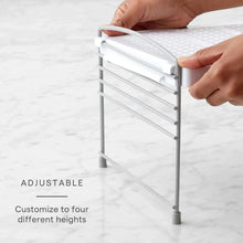 Adjustable white wire shelf frame being set to a new height