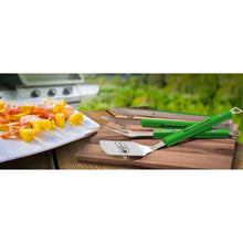 3-piece BBQ tool set with green Seahawks handles on grill, stainless spatula and fork