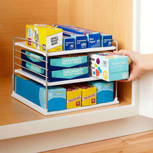 Metal cabinet shelf organizer with wire rack holding parchment and freezer bag boxes