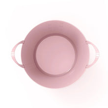 Pink flex storage bin top view, showing handle loops and circular inner rim