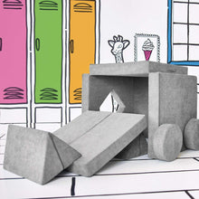 Gray play fort with triangular doorway, fold-out slide pieces, and rounded blocks