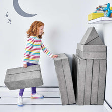 Gray convertible play fort with stacked upright panels and folding step blocks