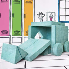Teal-green convertible kids play fort with stacked blocks, ramp panel, and storage ottoman