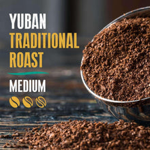 Bowl of dark coffee grounds with Yuban Traditional Roast medium roast text