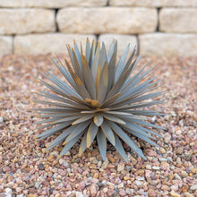 Yucca metal yard sculpture with radial spiky leaves on a round base