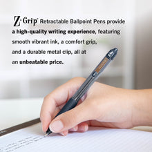 Hand holding a retractable ballpoint pen above lined notebook paper