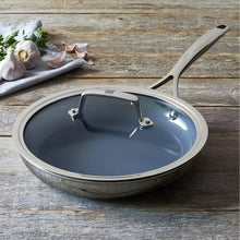 Stainless steel nonstick frying pan with black lid and long stay-cool handle