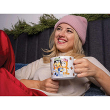 Person holding a ceramic holiday mug with character print and red interior