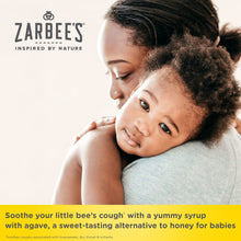 Baby with caregiver cuddle, Zarbee’s baby cough syrup label visible