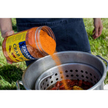Pouring Zatarain's Crawfish, Shrimp & Crab Boil seasoning into a steamer basket