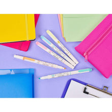 Assorted dual-tip highlighters with white barrels and colored tips, shown with pink pouch