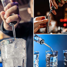 Stainless steel liquor pourer pouring liquid into a glass with black rubber dust cap