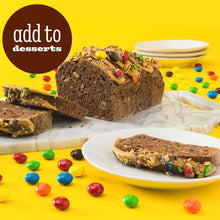 Chocolate dessert slices with multicolor M&M candies on serving tray