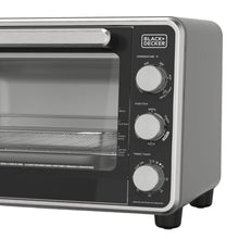 Air fryer toaster oven front panel with temperature and function dials, glass door