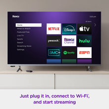 TV screen showing a Roku home menu with streaming channel tiles