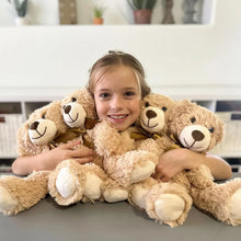 Brown plush teddy bears with bow ties, held as a group