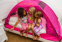 Pink arched bed tent with star pattern and open entrance, children playing inside
