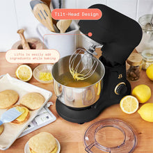 Black stand mixer with raised tilt head and balloon whisk over stainless steel bowl