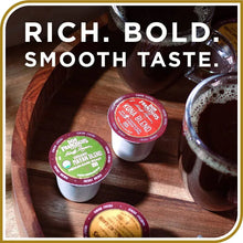 Coffee pod cups on wooden tray with brewed coffee in a glass