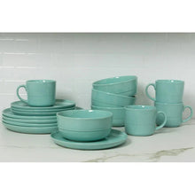 Seafoam green stoneware dinnerware set with stacked plates, bowls and mugs