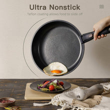 Black nonstick skillet with handle, egg cooking on a countertop