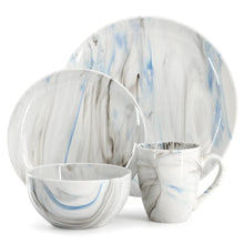 Porcelain dinner plates, bowls, and mugs with blue marble-style accents