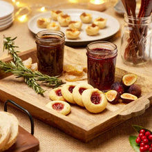 Regular-mouth mason jars with metal lids, filled with food, clear glass