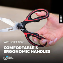 Kitchen scissors with black and red ergonomic handles and serrated cutting blades